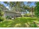 Large backyard with grassy area, patio, and mature trees at 401 28Th W St, Bradenton, FL 34205
