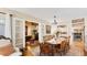 Classic dining room with wooden table and chairs, hardwood floors, and a view to the kitchen at 401 28Th W St, Bradenton, FL 34205