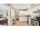 Modern kitchen with white cabinets, granite countertops, and stainless steel appliances at 401 28Th W St, Bradenton, FL 34205