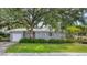Gray house with a white garage door and manicured lawn at 401 28Th W St, Bradenton, FL 34205