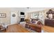 Spacious living room featuring hardwood floors, a fireplace, and comfortable leather furniture at 401 28Th W St, Bradenton, FL 34205
