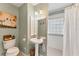 Bathroom with pedestal sink, shower with glass block window and updated fixtures at 401 28Th W St, Bradenton, FL 34205
