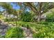 Landscaped backyard with large oak tree and brick patio at 401 28Th W St, Bradenton, FL 34205