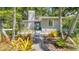Charming house with landscaped front yard, walkway, and mature trees at 401 28Th W St, Bradenton, FL 34205