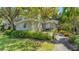 Gray house with mature trees and a landscaped yard at 401 28Th W St, Bradenton, FL 34205