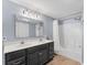 Double vanity bathroom with a shower/tub combo and updated fixtures at 401 28Th W St, Bradenton, FL 34205