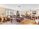 Open living and dining area with hardwood floors, leather furniture, and a view to the dining area at 401 28Th W St, Bradenton, FL 34205