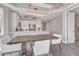 Elegant dining area with a rustic wooden table and white chairs at 10520 Boardwalk Loop # 605, Lakewood Ranch, FL 34202