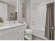 Clean bathroom with a tub, shower, and updated white vanity at 10520 Boardwalk Loop # 605, Lakewood Ranch, FL 34202