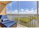 Relaxing screened balcony with chaise lounge and lake views at 10520 Boardwalk Loop # 605, Lakewood Ranch, FL 34202