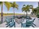 Relaxing fire pit area with seating, overlooking a lake at 10520 Boardwalk Loop # 605, Lakewood Ranch, FL 34202