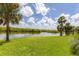 Scenic waterfront view with lush landscaping and palm trees at 10520 Boardwalk Loop # 605, Lakewood Ranch, FL 34202