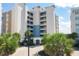 Condo building entrance with palm trees and paved driveway at 10520 Boardwalk Loop # 605, Lakewood Ranch, FL 34202