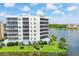 Lakefront condo building with balconies and lush landscaping at 10520 Boardwalk Loop # 605, Lakewood Ranch, FL 34202
