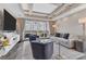 Living room with water views, featuring a large TV and comfortable sofas at 10520 Boardwalk Loop # 605, Lakewood Ranch, FL 34202