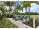 Enjoyable fire pit area with green Adirondack chairs and lush landscaping at 10520 Boardwalk Loop # 605, Lakewood Ranch, FL 34202