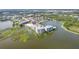 Aerial view of waterfront property, showcasing the building and surrounding lake at 10520 Boardwalk Loop # 605, Lakewood Ranch, FL 34202