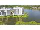 Lakefront condo building with reflection in calm waters at 10520 Boardwalk Loop # 605, Lakewood Ranch, FL 34202
