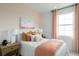 Bright bedroom with a queen bed, wood nightstand, and peach colored bedding at 9975 Key Haven Rd, Seminole, FL 33777