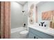 Clean bathroom with a tub, shower, and light-colored tile at 9975 Key Haven Rd, Seminole, FL 33777