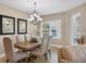 Elegant dining room featuring a rustic wood table and chandelier at 3412 79Th Street W Cir # 101, Bradenton, FL 34209