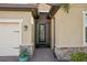 Inviting front entry with a screened door and brick walkway at 10132 Colubrina Dr, Venice, FL 34293