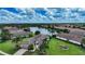Aerial view of home with beautiful landscaping, lawn, and lake view at 12663 Fontana Loop, Bradenton, FL 34211