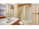 Bathroom with a vanity, toilet, and bathtub with a striped wallpaper accent at 12663 Fontana Loop, Bradenton, FL 34211
