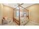 Cozy bedroom featuring a four-poster bed, a ceiling fan, and a wicker chair at 12663 Fontana Loop, Bradenton, FL 34211
