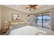 Bright bedroom featuring large windows, tray ceiling with fan, and neutral decor at 12663 Fontana Loop, Bradenton, FL 34211