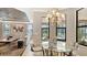Bright dining area with a glass table, chandelier, and views of the pool at 12663 Fontana Loop, Bradenton, FL 34211