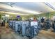 Modern gym with various exercise machines, mirrors, and ceiling fans, promoting a healthy lifestyle at 12663 Fontana Loop, Bradenton, FL 34211