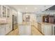 Bright kitchen featuring cream-colored cabinets, granite counters, stainless appliances, and an island at 12663 Fontana Loop, Bradenton, FL 34211