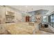Bright kitchen seamlessly connected to a living area, featuring granite counters and stainless appliances at 12663 Fontana Loop, Bradenton, FL 34211