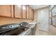 Laundry room with new washer, dryer, and plenty of storage cabinets above the sink at 12663 Fontana Loop, Bradenton, FL 34211
