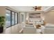 Bright living area featuring neutral tones, large sliding glass doors, and comfortable seating at 12663 Fontana Loop, Bradenton, FL 34211