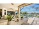 Outdoor patio features travertine tile, seating, and panoramic views of pool and lake at 12663 Fontana Loop, Bradenton, FL 34211