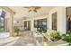 Covered outdoor patio features stone flooring, comfortable seating, and access to the outdoors at 12663 Fontana Loop, Bradenton, FL 34211