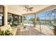 Outdoor patio with screened enclosure featuring lounge furniture and a view of the pool and lake at 12663 Fontana Loop, Bradenton, FL 34211