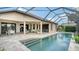 Backyard showcasing a pool, patio area with seating, and serene waterfront views at 12663 Fontana Loop, Bradenton, FL 34211