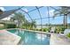 A beautiful pool area with screened enclosure offers a serene view of the lake at 12663 Fontana Loop, Bradenton, FL 34211