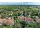 Aerial view of community with lush landscaping and tile roofs at 264 Woods Point Rd, Osprey, FL 34229