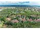 Stunning aerial view highlights the community's homes surrounded by green landscape near the waterways at 264 Woods Point Rd, Osprey, FL 34229