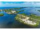 A lovely community with bridge access and bay view from an aerial perspective on a clear day at 264 Woods Point Rd, Osprey, FL 34229