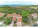 Aerial view of two-story home with tile roof and two-car garage at 264 Woods Point Rd, Osprey, FL 34229