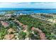 Aerial view of a residential community surrounded by lush greenery and stunning waterfront views at 264 Woods Point Rd, Osprey, FL 34229