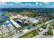 Stunning aerial view of waterfront properties, showcasing covered boat slips, lush landscaping, and neighborhood's vibrant community at 264 Woods Point Rd, Osprey, FL 34229