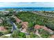 Beautiful aerial view showcases the community's lush landscaping and its proximity to the ocean at 264 Woods Point Rd, Osprey, FL 34229