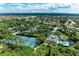 Wide aerial view shows the community featuring tennis courts, a pool, and well-maintained surroundings at 264 Woods Point Rd, Osprey, FL 34229
