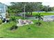 Outdoor amenity area featuring a fire pit, benches, and palm trees, great for relaxing and entertaining at 264 Woods Point Rd, Osprey, FL 34229